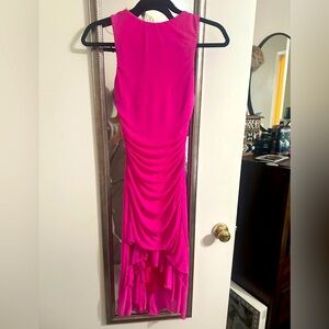 Pink dress perfect for a wedding guest! Ruffles on the bottom and open low back
